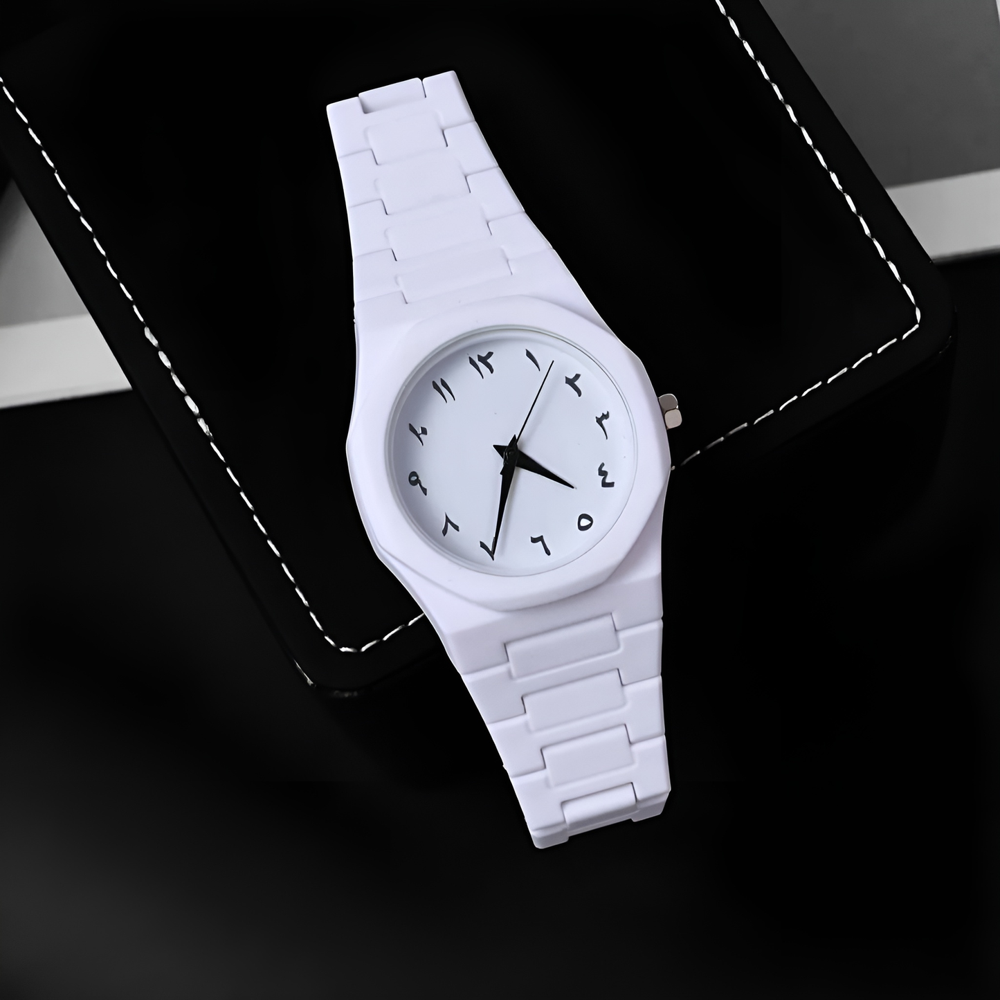 White ceramic watch on a black background