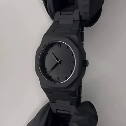 Black wristwatch on a plain background