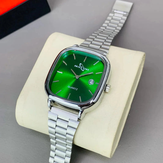 Wristwatch with green face and silver metal strap on a beige stand